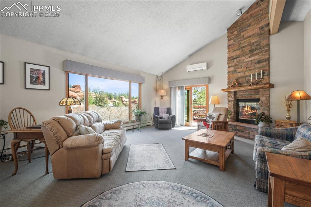 Image 7 of 49: Living room featuring a huge picture window overlooking the red rock outcro
