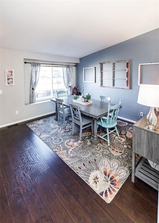 Image 11 of 42: Dining room featuring dark wood finished floors