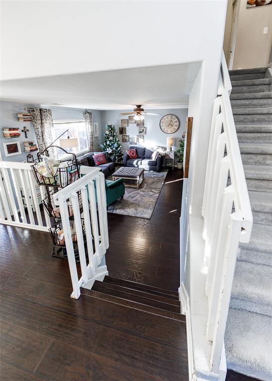 Image 20 of 42: Stairway featuring hardwood / wood-style floors and a ceiling fan