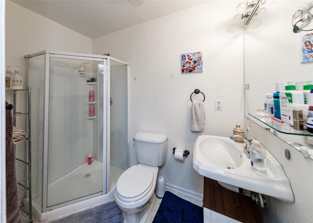 Image 30 of 42: Full bath with a stall shower and tile patterned flooring