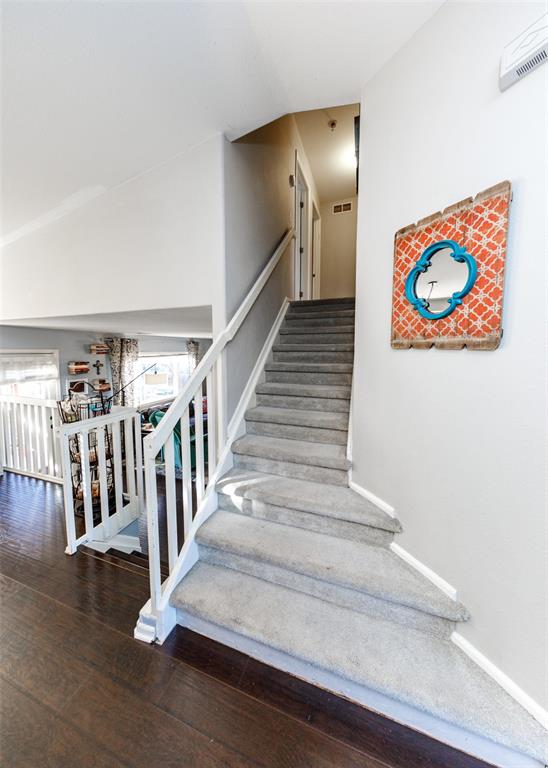 Image 31 of 42: Stairway with baseboards and wood finished floors