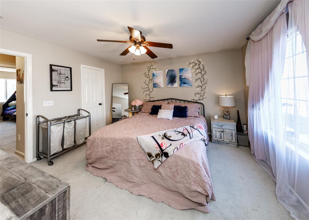 Image 34 of 42: Carpeted bedroom featuring a ceiling fan