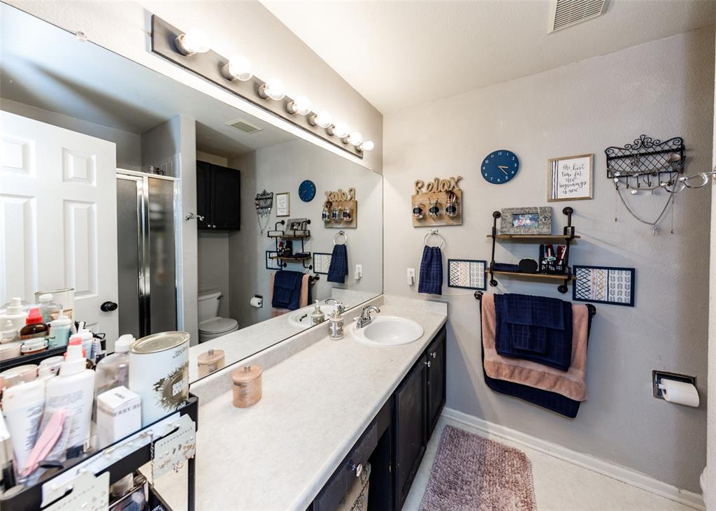 Image 36 of 42: Full bath featuring vanity, a shower stall, and light tile patterned floors