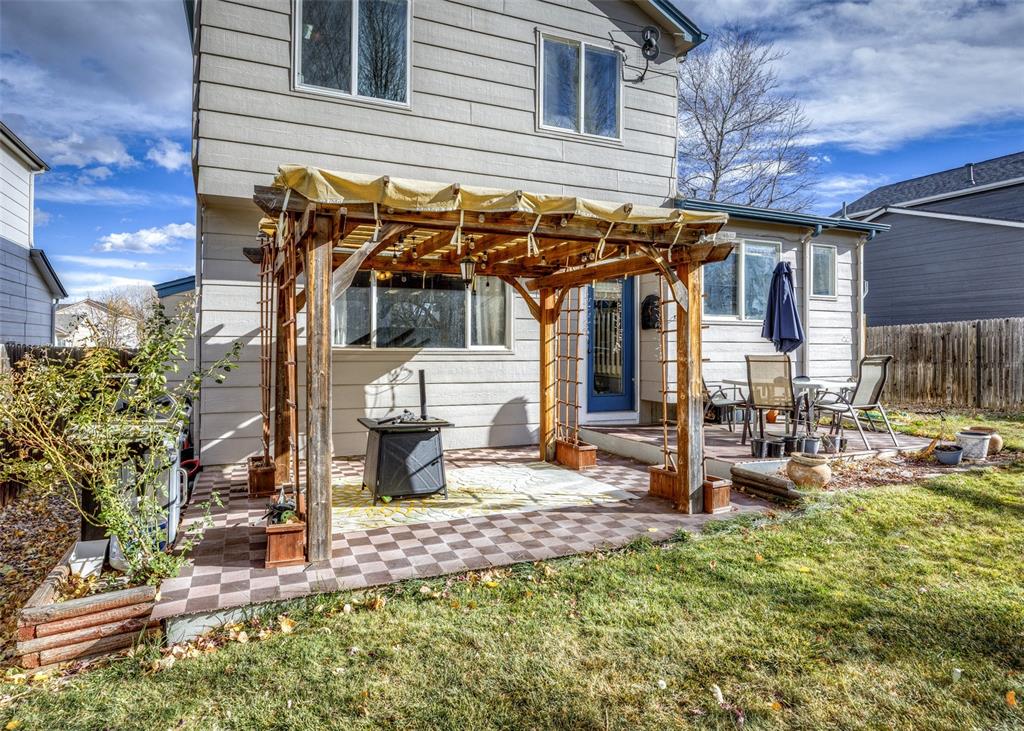 Image 4 of 42: Rear view of house with a pergola and a patio area
