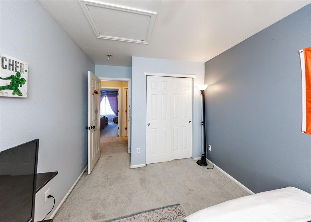 Image 40 of 42: Bedroom featuring light colored carpet, a closet, and attic access