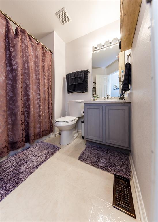 Image 41 of 42: Bathroom with vanity, curtained shower, and light tile patterned floors