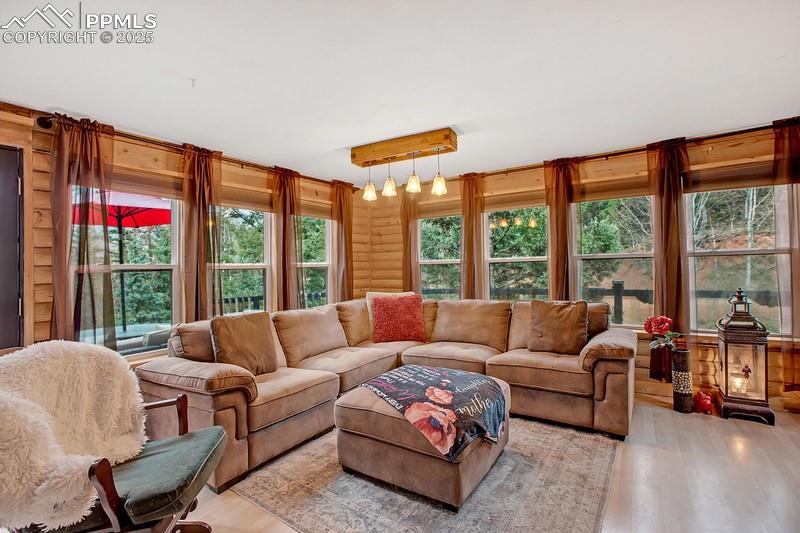 Image 15 of 27: Living room with light wood finished floors