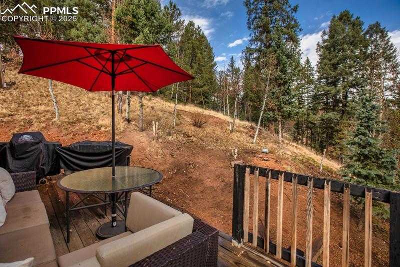 Image 7 of 27: View of yard featuring a wooden deck