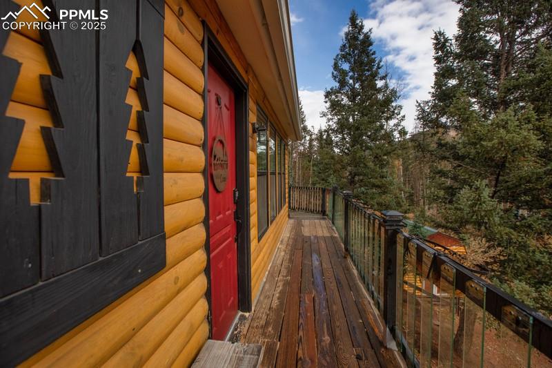 Image 8 of 27: View of side of property with faux log siding