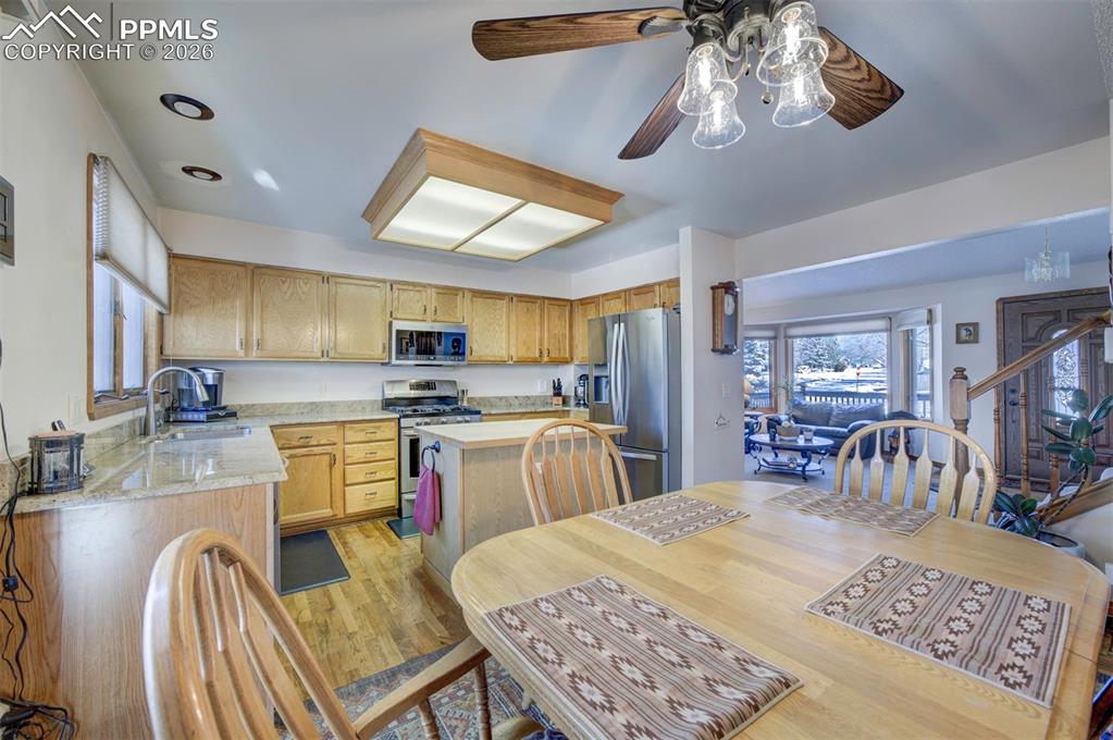 Image 10 of 38: Granite countertops, butcher block island, wood flooring, trash compactor, 