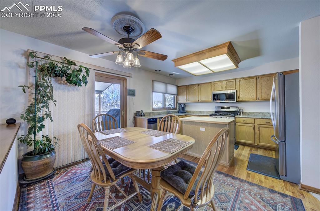 Image 11 of 38: Wood flooring and walk out to covered back deck