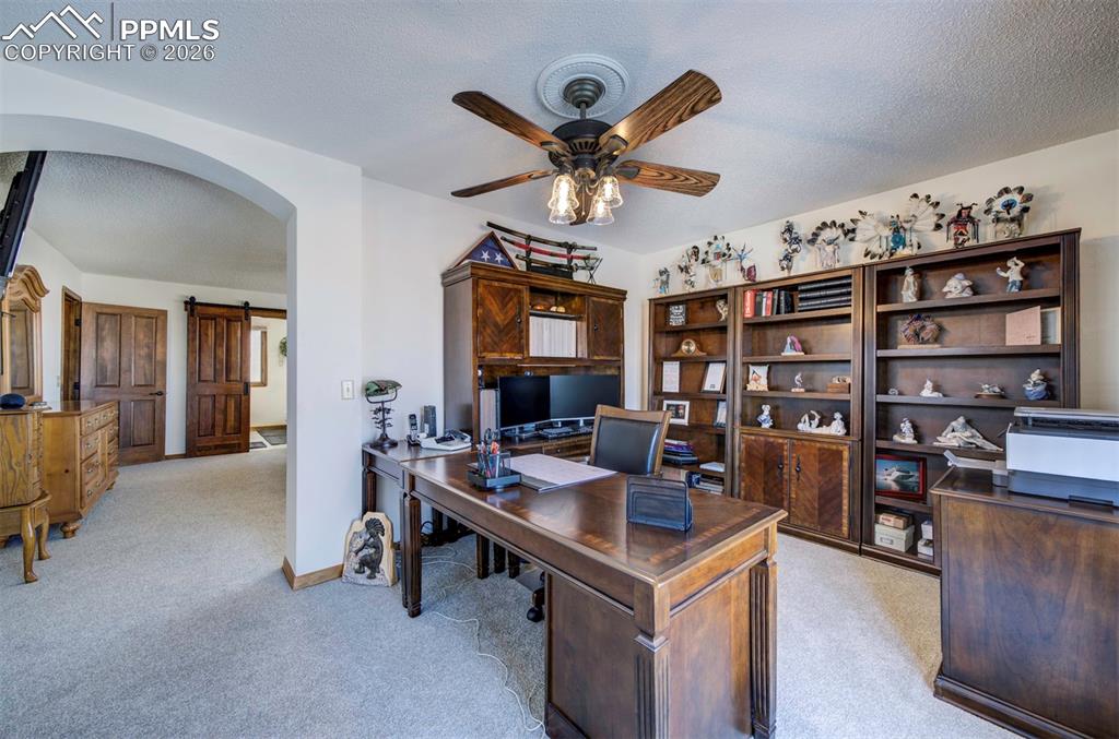 Image 21 of 38: Primary bedroom with bonus room to walk out to deck