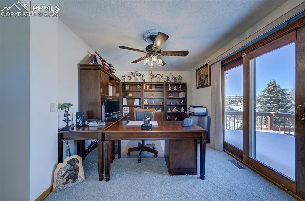 Image 22 of 38: Primary bedroom with bonus room to walk out to deck