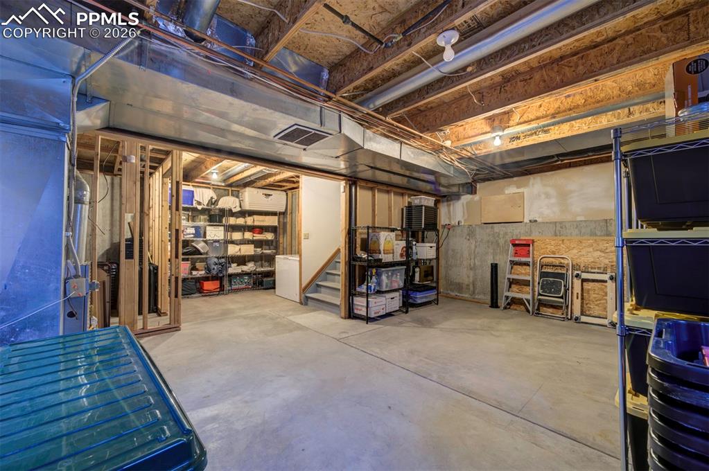 Image 29 of 38: Unfinished basement with framing