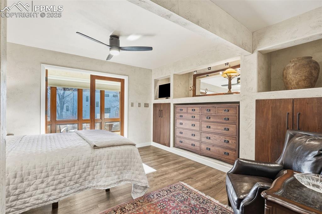 Image 21 of 46: Primary Bedroom adjoins one of the greenhouse rooms