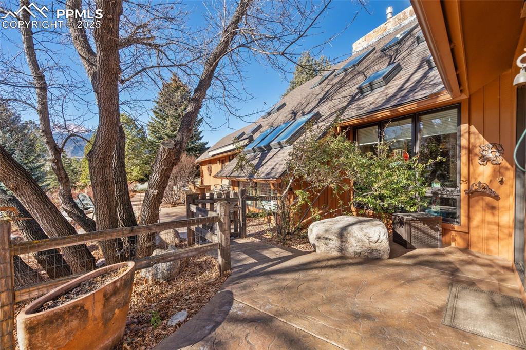 Image 33 of 46: Front of house from one of the patios