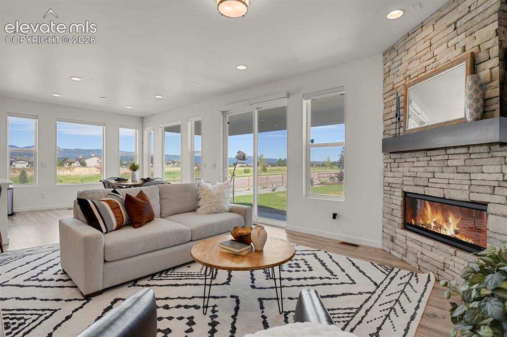 Image 4 of 44: Living room with fireplace and beautiful wood mantel.