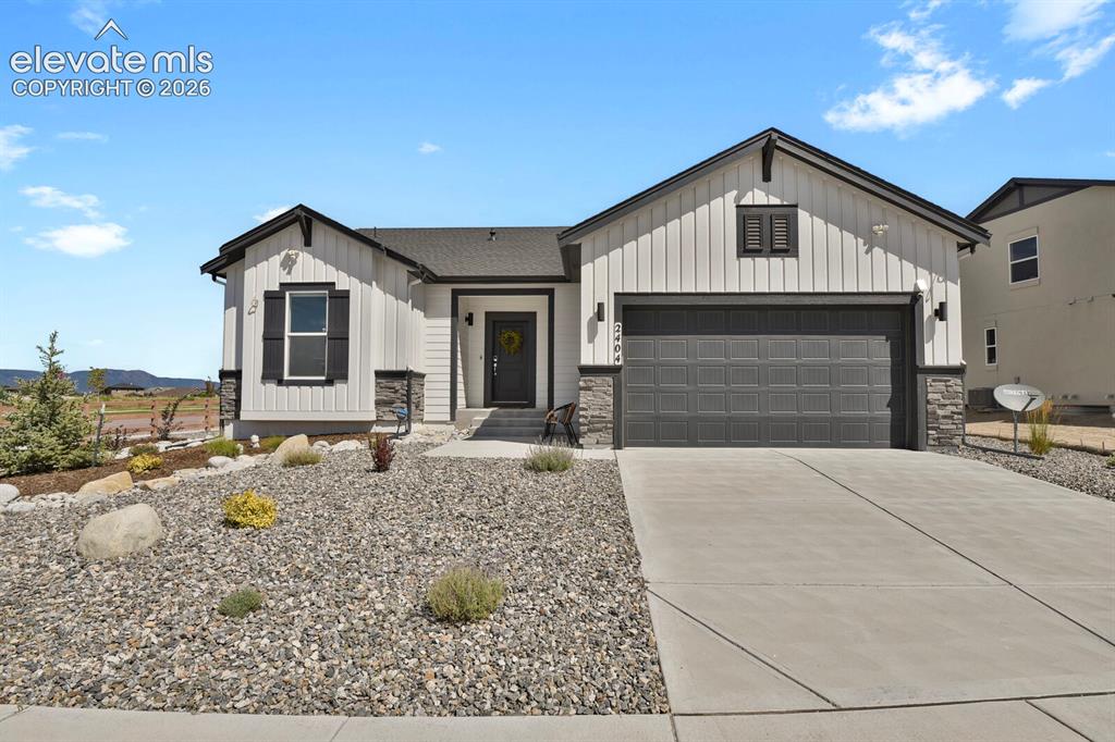 Image 5 of 44: Xeriscape front yard for easy maintenance.
