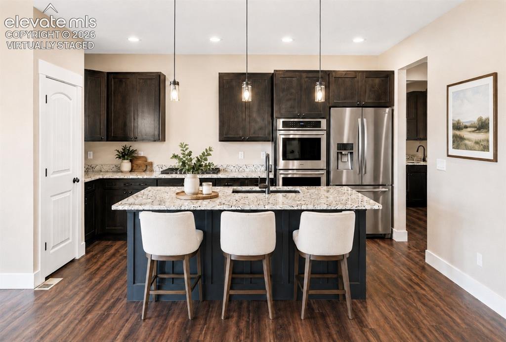 Image 10 of 40: Virtually Staged Modern kitchen featuring a central island with seating, gr