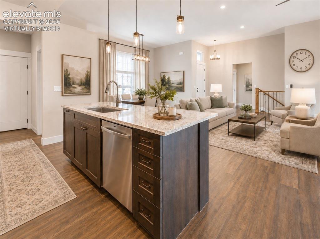 Image 12 of 40: Virtually Staged Open-concept living space featuring wood-finish flooring,