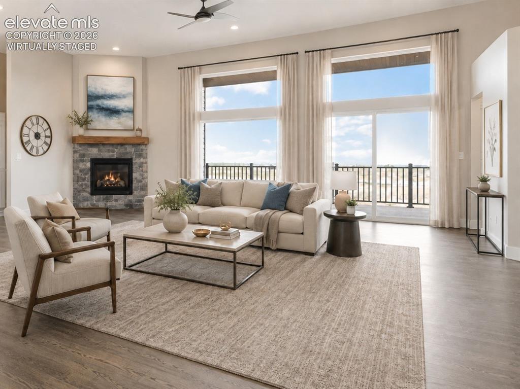 Image 14 of 40: Virtually Staged Spacious living area featuring expansive windows with slid