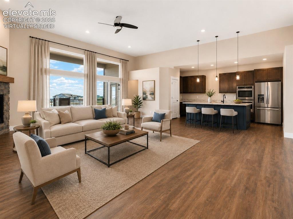 Image 16 of 40: Virtually Staged Spacious open-concept living area featuring wood-finish fl