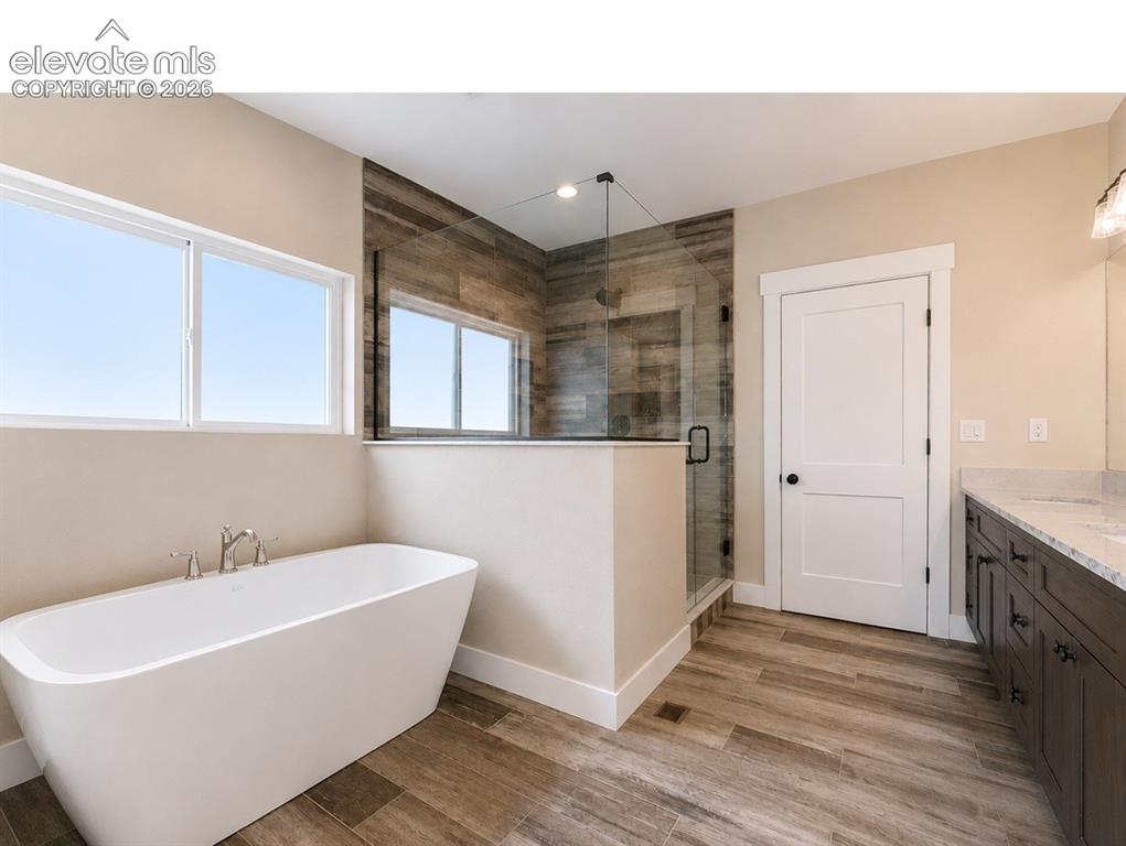 Image 23 of 40: Contemporary bathroom featuring a freestanding soaking tub, a glass-enclose