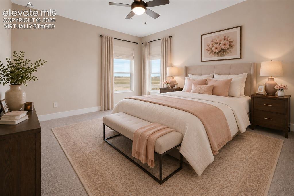 Image 26 of 40: Virtually Staged Spacious sleeping area featuring a ceiling fan, plush carp