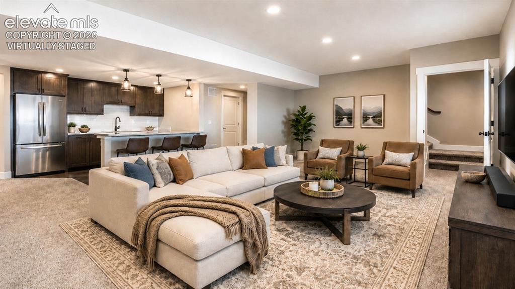 Image 33 of 40: Virtually Staged Basement living room and wet bar