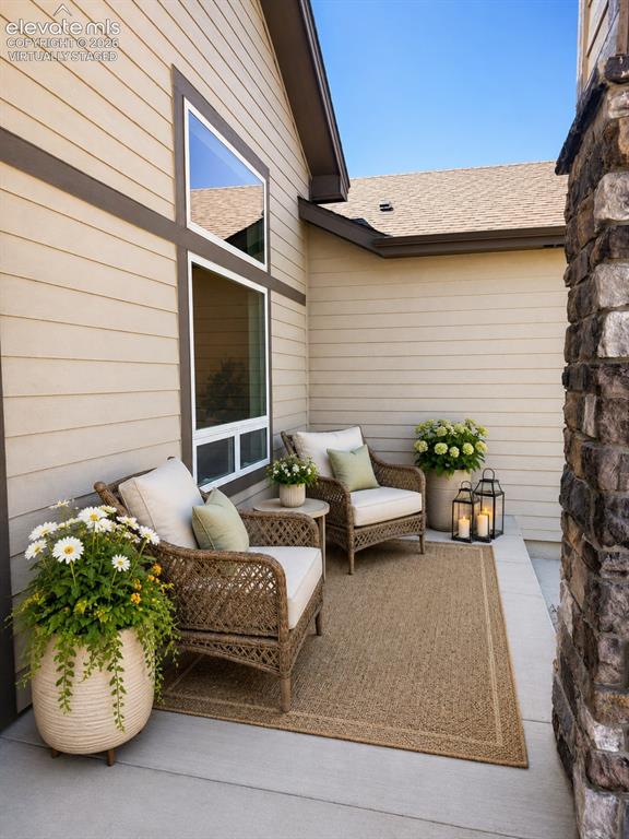 Image 4 of 40: Virtually Staged Outdoor patio with concrete flooring, accented by a woven