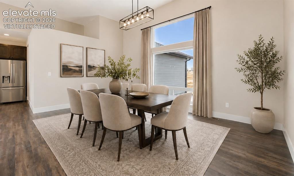 Image 6 of 40: Virtually Staged Dining area featuring wood-finish flooring, a contemporary