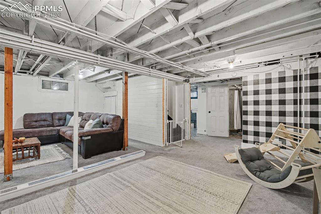 Image 23 of 37: split concept makes convenient game area and sitting area