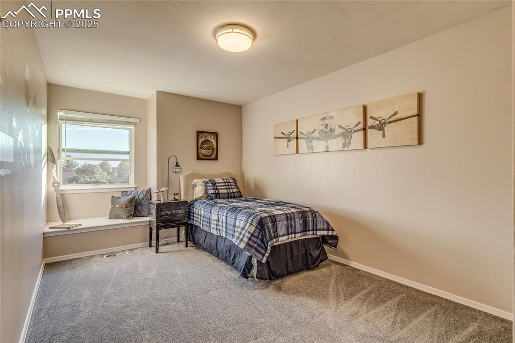 Image 10 of 31: Upper bedroom with window seat.
