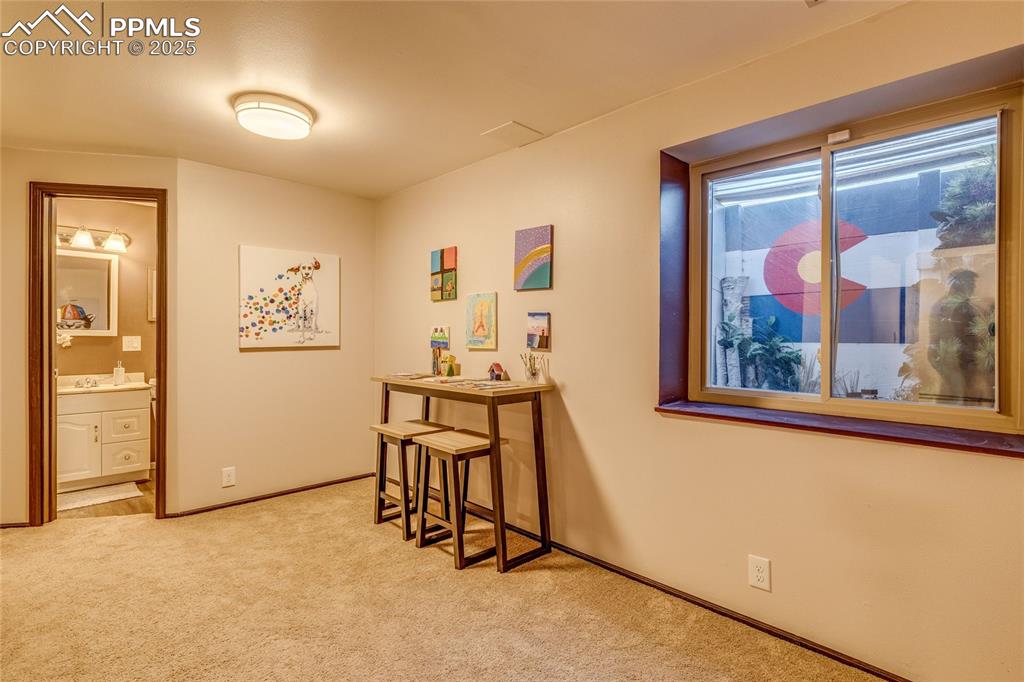 Image 18 of 31: Basement area for crafts, sewing area or kids area. Love the Colorado windo
