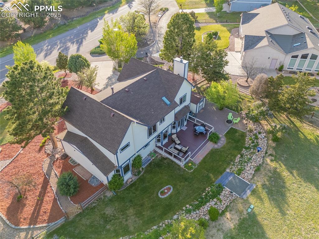 Image 26 of 31: Aerial view of home and the nice landscaped, oversized yard