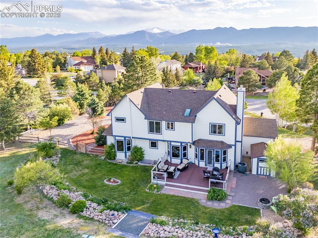 Image 27 of 31: Ariel view of home with landscaped yard
