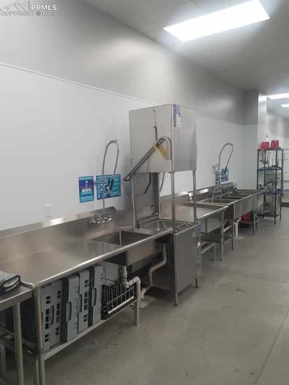 Image 11 of 14: Miscellaneous room featuring concrete floors