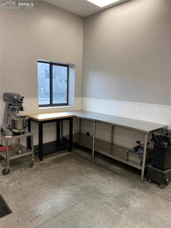 Image 8 of 14: Office area featuring concrete flooring