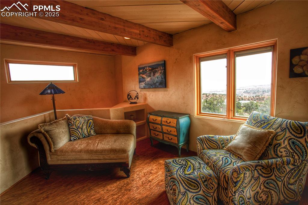 Image 12 of 20: Sitting room featuring wooden ceiling, hardwood floor and walkout to privat