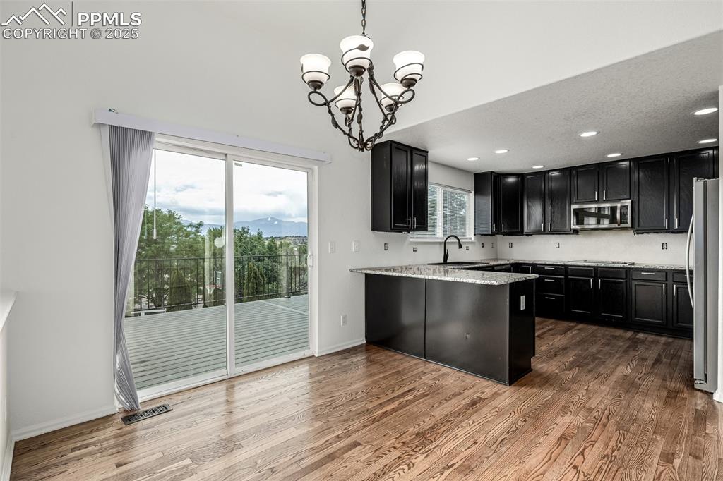 Image 11 of 35: The eat in dining nook opens to the back deck showcasing the stunning mount