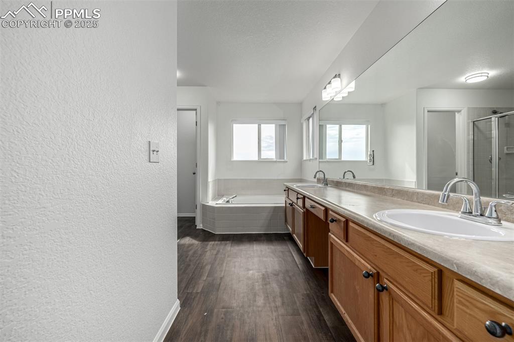 Image 18 of 35: This en suite bathroom features double sinks with an oversized vanity. 