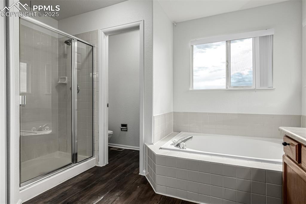 Image 19 of 35: Soak off the day in this large garden tub or private shower. 