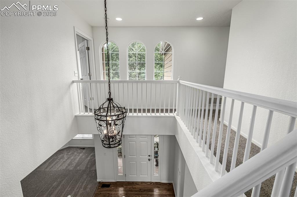 Image 2 of 35: Entering the home you are greeted by a grand staircase and natural light