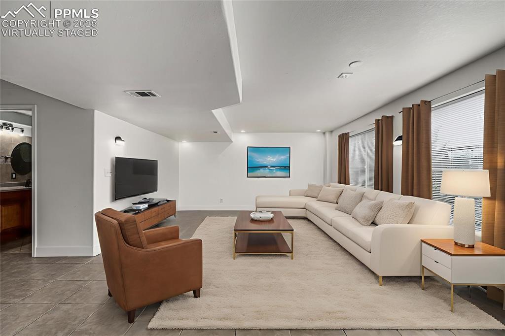 Image 25 of 35: Enjoy the spacious media room or secondary living space in the walk out bas
