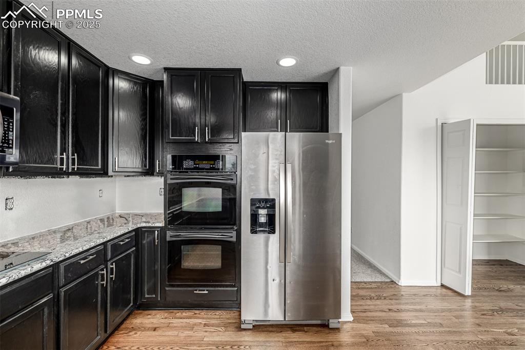 Image 9 of 35: The double ovens, new stove range and side by side refrigerator are just wh