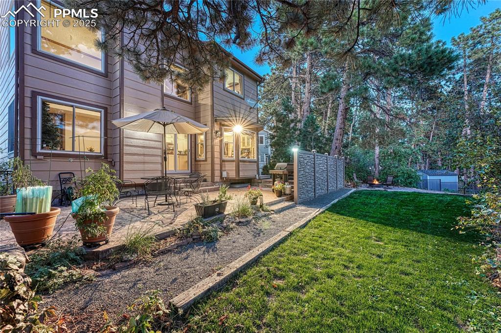 Image 13 of 48: Fenced Backyard with wrought iron fencing, Stamped concrete patio, hot tub