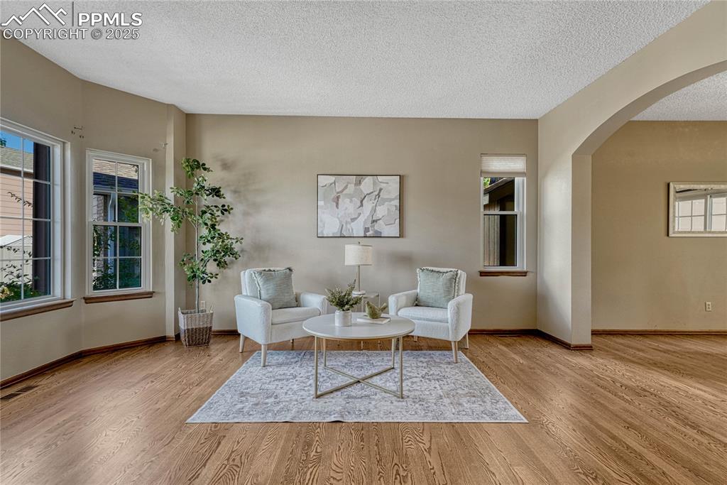 Image 20 of 48: Living room with hardwood flooring
