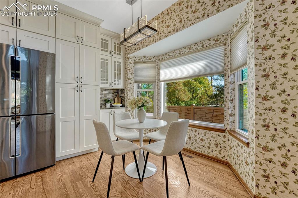Image 26 of 48: View of Breakfast nook and one of two cabinet pantries with roll-out shelvi
