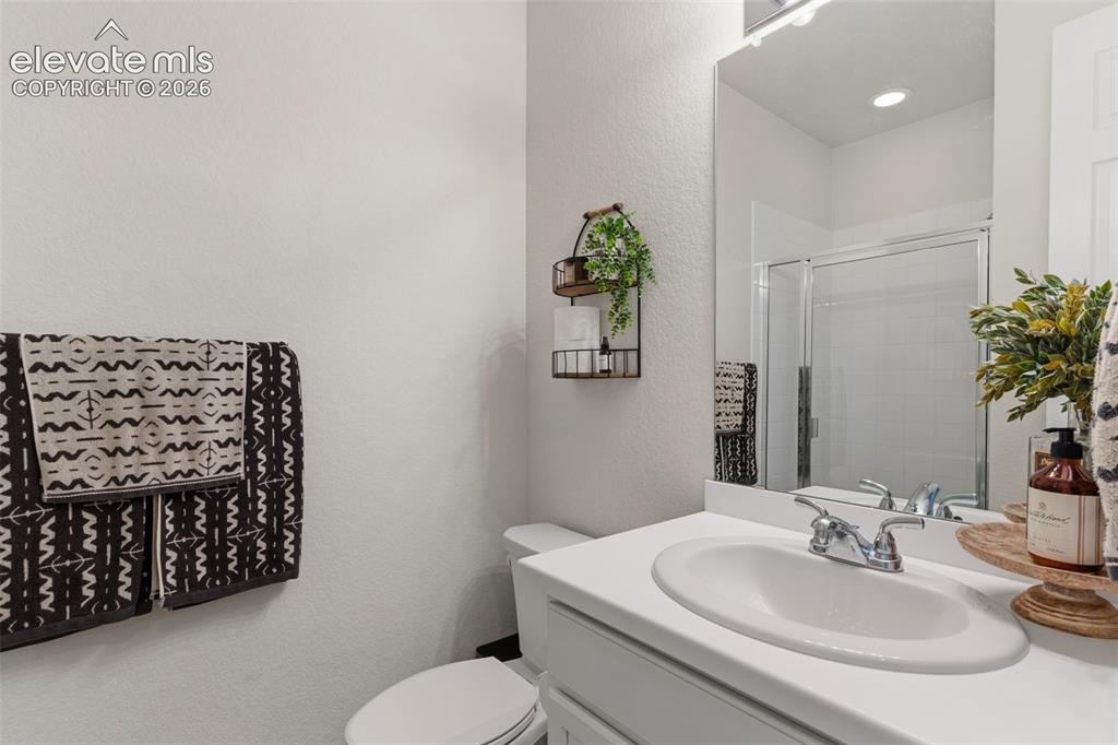 Image 16 of 33: Bathroom featuring a white vanity with an integrated sink, chrome faucet, a