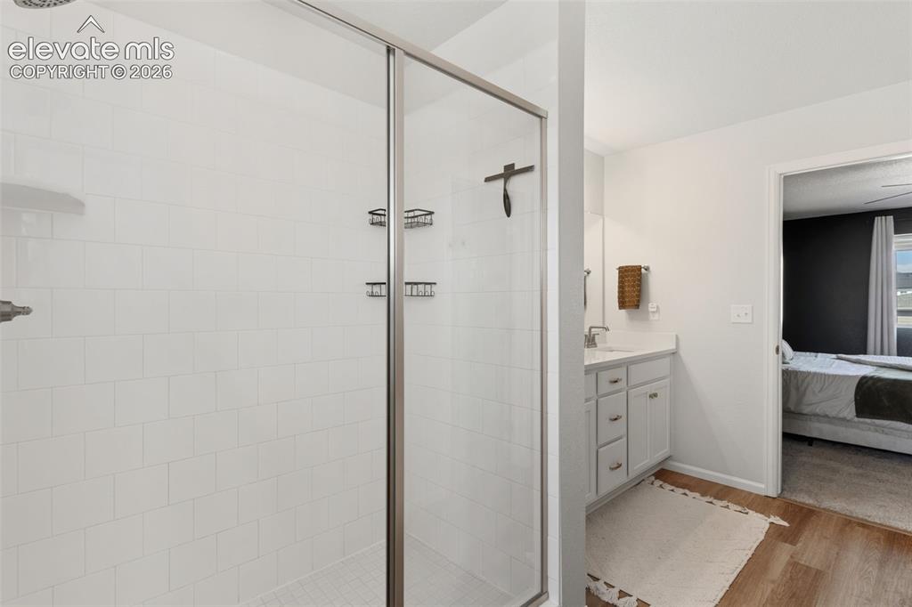 Image 20 of 33: Walk-in shower featuring a frameless glass enclosure, white subway tile sur